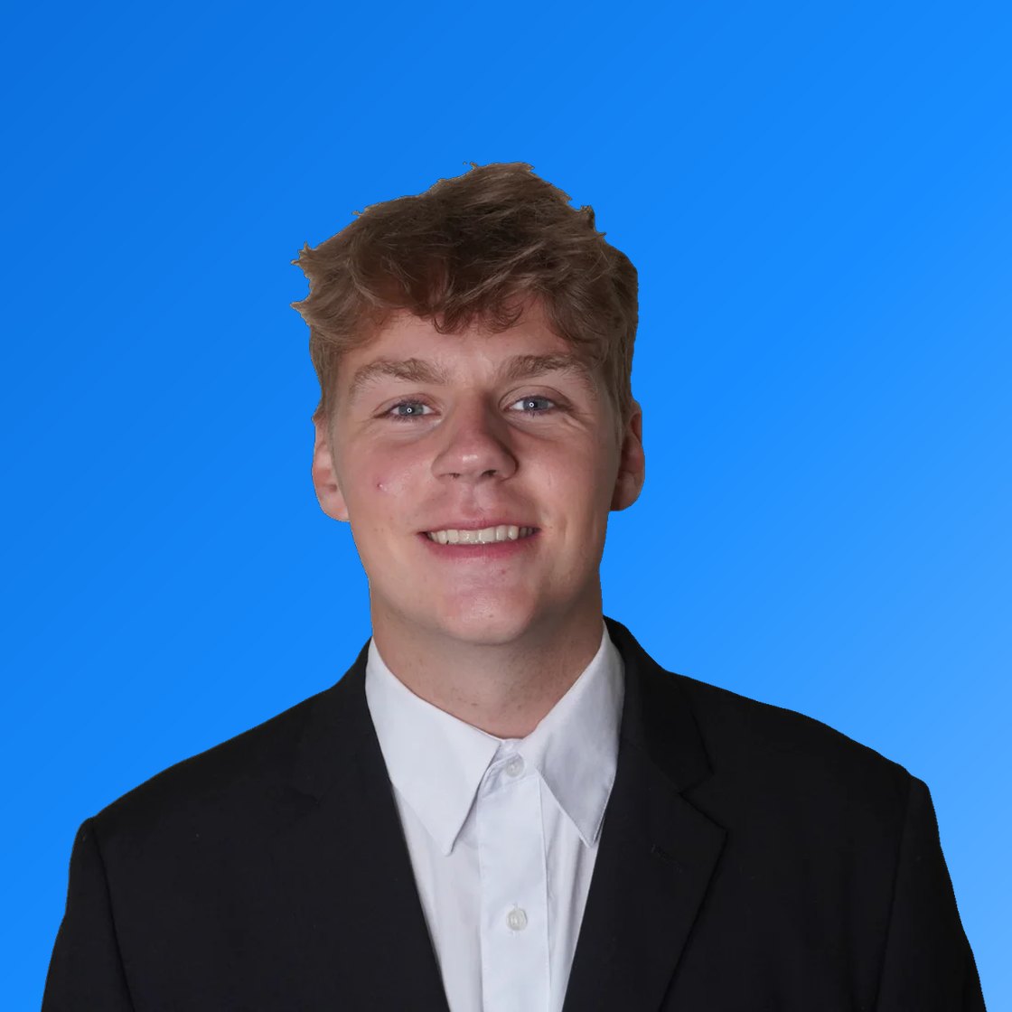 Jesse Gaskins, smiling, in a dark suit and white shirt, on a blue background